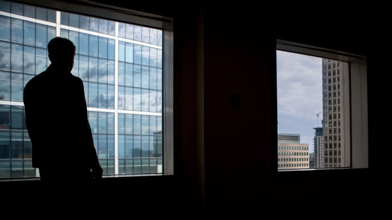 Silhouette of business man at window